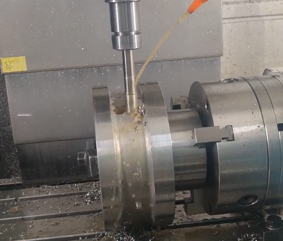 CNC milling machine processing raw material into finished parts
