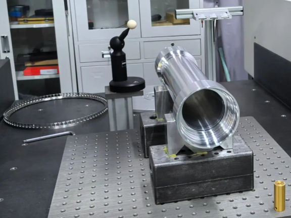 Engineer inspecting aerospace CNC machined parts for quality control