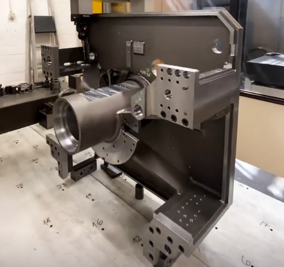 Engineer inspecting CNC machined parts for energy applications