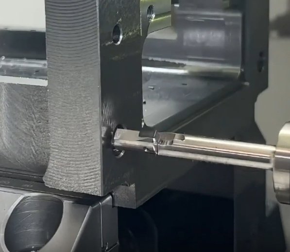 CNC drilling machine performing precision hole machining on metal component