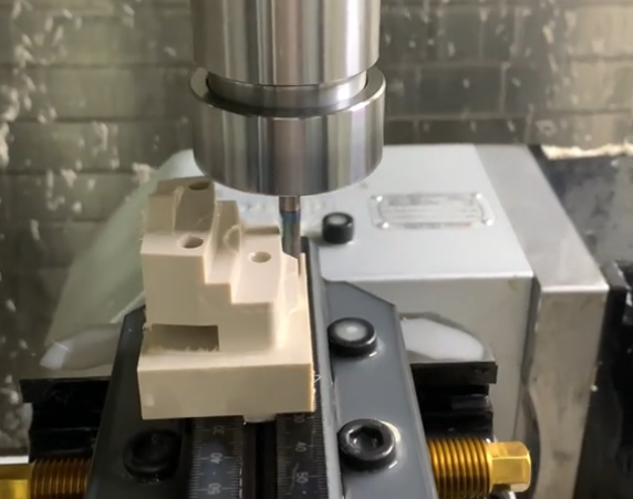 CNC milling machine cutting high-precision plastic parts