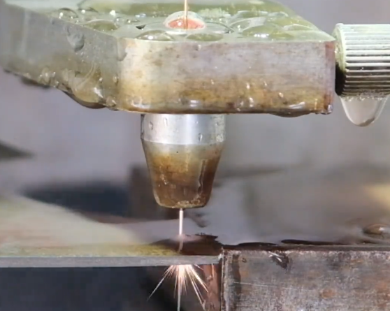 Close-up of wire EDM cutting steel plate