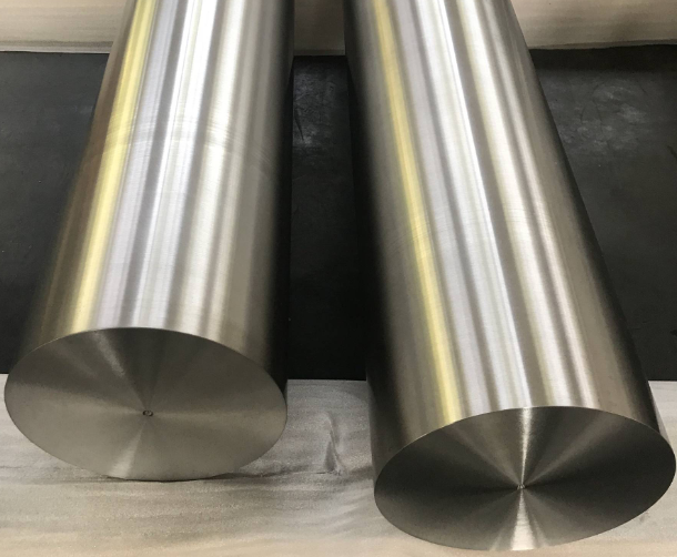 Titanium alloy rods and bars displayed in an industrial warehouse